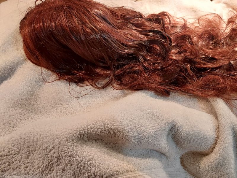 After washing synthetic wigs, lay them on towels to dry